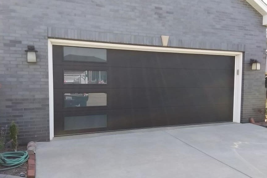 brand new black flush pannel modern garage door with large sindows - Glenn Brothers - Springfield, IL