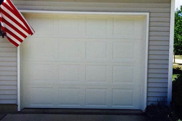 Badly damaged residential garage door after repair- Glenn Brothers - Springfield, IL
